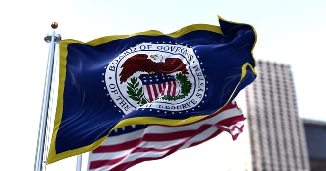 Washington D.C., USA, March 2022: The flag of the American Federal Reserve System waving in the wind with the flag of the United States blurred in the background. the Fed is the central bank of the United States of America