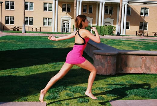A lovely model female model jumping outdoors