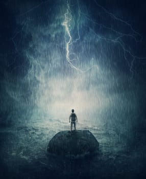 Alone man stands on a small rock island, lost in the middle of the ocean under the stormy night sky. Failure and despair concept, seeking for help. Life crisis, surviving a hopeless situation