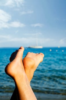 Female feet relaxing on the beach