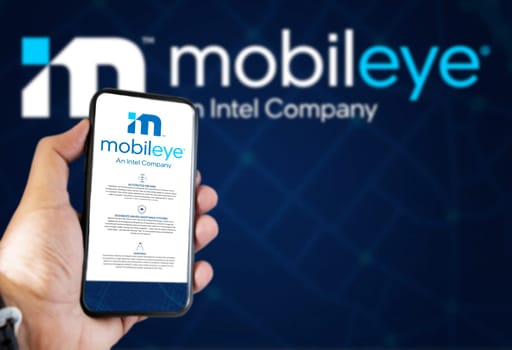 Jerusalem, ISR, March 2022: Mobileye company’s website on a phone screen. Blue background with Mobileye logo blurred in the background. Illustrative editorial. Realistic mockup. Selective focus.