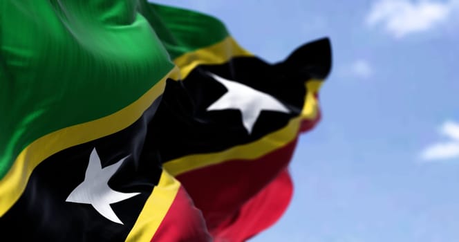 Detail of the national flag of Saint Kitts and Nevis waving in the wind on a clear day. Saint Kitts and Nevis is an island country in the West Indies. Selective focus.