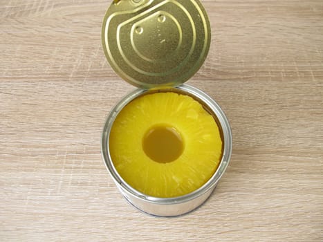 A can of pineapple slices in juice