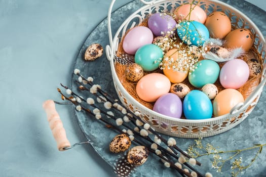 Easter eggs on plate with pussy willow branch