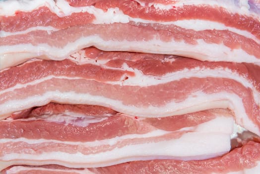 Closeup top view pieces fresh raw meat of pork belly with white fat and red pink meat
