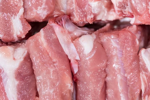 Close up top view pack pieces raw meat of pork loin on bone, fresh red pork with white fat of pork rib, Cut into pieces and put them in a row