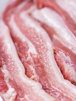 Closeup top view pieces fresh raw meat of pork belly with white fat and red pink meat