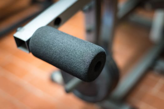 Black desk of free space for your decoration and blurred gym interior.Metal dumbbells and fit life