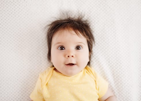 Cute little baby lying on the white blanket. Concept of childhood and new life.