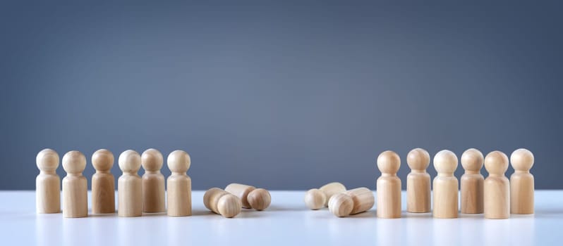 Abstract photography with figurines of wooden men on the grey background. Concept of the military attack, war, demonstration and confrontation.