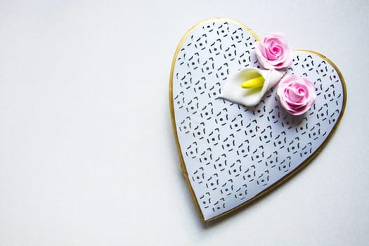 Big heart with colorful and sweet icing flowers, top view