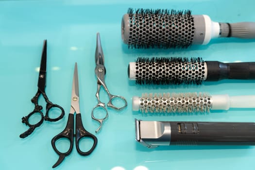 Hairdresser tools on modern background with copy space in center.