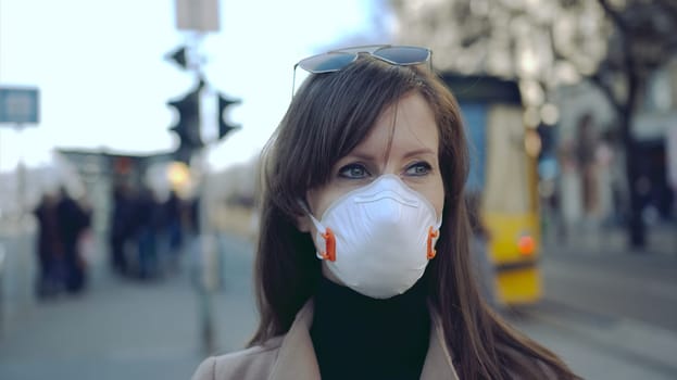 Covid-19 coronavirus protection - Woman in protective face mask in an empty european city.