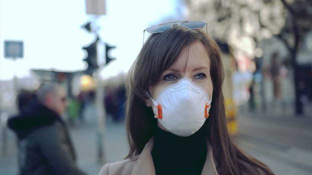 Coronavirus disease - woman wearing face mask in public to protect herself from the covid-19 virus.