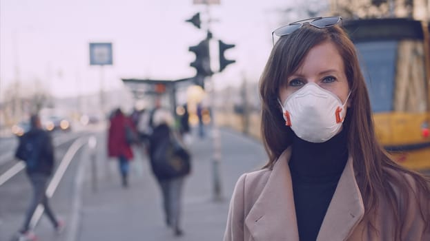 Covid-19 coronavirus protection - Woman in protective face mask in an empty european city.