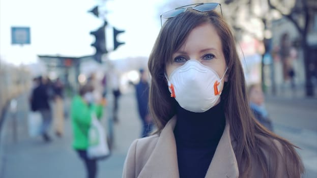 Covid-19 coronavirus protection - Woman in protective face mask in an empty european city.