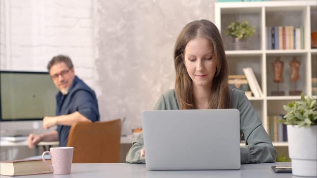 Business people working in office with laptop computer. Woman working from home at desk.