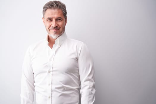 Business portrait - businessman smiling. Mature age, middle age, mid adult man in 50s with happy confident smile. Copy space.
