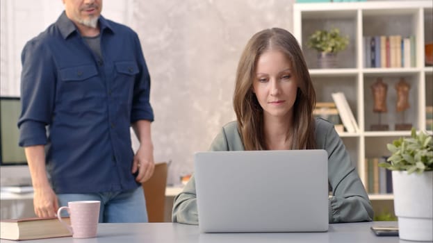 Business people working in office with laptop computer. Woman working from home at desk.