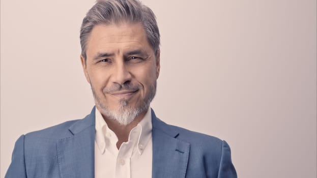 Business portrait - businessman smiling. Mature age, middle age, mid adult man in 50s with happy confident smile. Copy space.