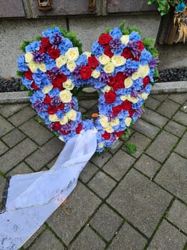 Heart of roses in front of a grave