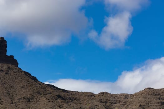 Mountains on the coast between Puerto de Mogan and Puerto Rico. Layers of volcanic rock.
