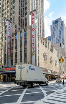 Radio City Music Hall at New York City, traffic in the forefront during daytime, vertical