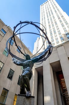 Atlas Statue Monument at Rockefeller Center, low angle view during daytime with clear sky, vertical