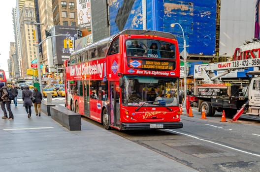 Red New York Sightseeing Bus parked at Time Square, lots of Tourist sitting in it, Time Square New York City, horizontal