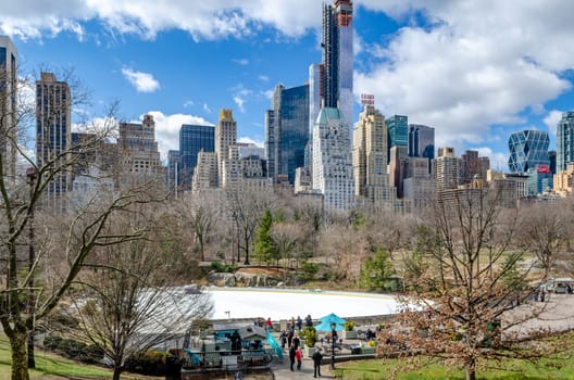 Wollman Rink during winter with no people on the ice as it gets renewed, skyline of Manhattan, great weather during daytime, New York City, horizontal
