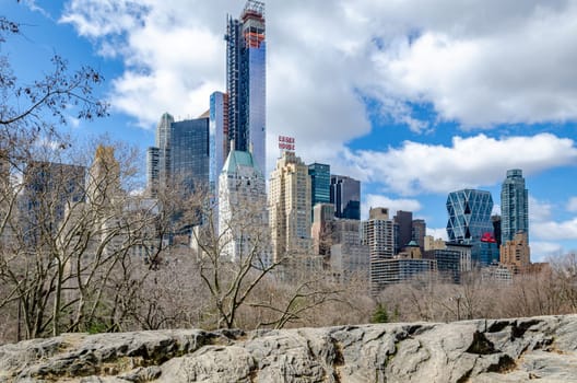 Manhattan Skyline during daytime view from Central Park New York City with rocks in the forefront, winter, horizontal