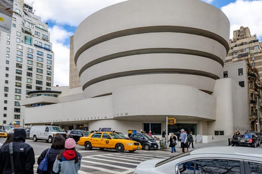 Solomon R. Guggenheim Museum, New York City, with traffic and crosswalk in the forefront during daytime in winter, view from low angle, horizontal