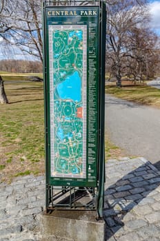 Central Park New York Information Map standing at the entrance of the Park during winter, vertical