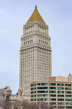 Thurgood Marshall United States Courthouse Tower with yellow roof and building with green windows in the forefront, New York City, overcast, vertical