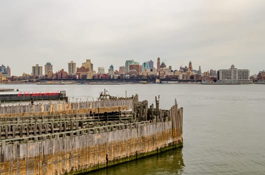 Brooklyn Skyline with Staten Island Ferry Battery Maritime Building Slip 5 wood jetty in forefront, during winter, horizontal