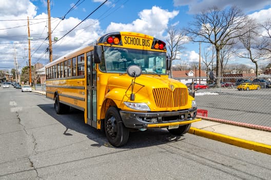 Yellow School Bus at Cliffside Park, front view, New Jersey, during a sunny winter day, no people, horizontal