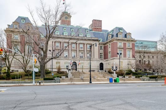 Staten Island Borough Hall, New York City, with staircase and road in the forefront, no people, no traffic, during winter day with overcast, horizontal