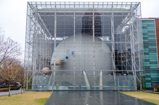 The Hayden Planetarium Building at New York City during rainy winter day with overcast, different Planets, close-up, horizontal