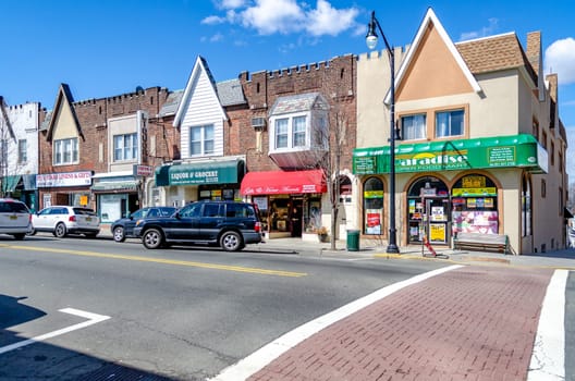 Different Retail Stores at the Center of the City near Cliffside Park, New Jersey, during a sunny winter day, Cars parked next to the street, horizontal