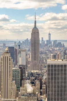 Empire State Building Aerial View from Rockefeller Center with One World Trade Center construction site in the background, New York City during winter, vertical
