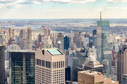 East River with Skyscraper of Manhattan in the front, aerial view from Rockefeller Center during winter, horizontal