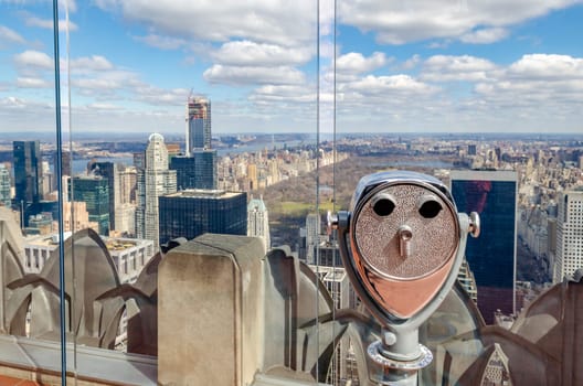 Central Park New York City with binoculars and glass fence in the front, aerial view from Rockefeller Center during winter, horizontal