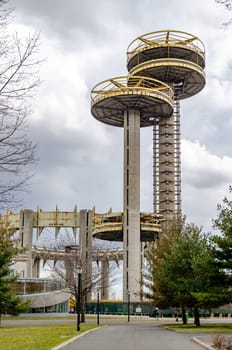 New York State Pavilion Observation Towers with Queens Theatre, way and trees in front, Flushing-Meadows-Park, New York City during overcast winter day, vertical