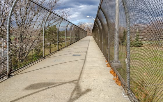Bridge to Flushing-Meadows-Park over Highway in Queens, New York City during overcast winter day, horizontal