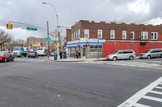 The Lemon Ice King of Corona, Ice Cream Retail Store wide angle, with traffic and people, Queens, New York City during overcast winter day, horizontal