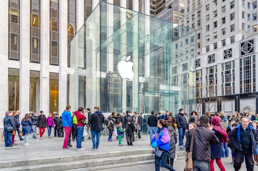 Apple Store Entrance Glass Cube, Manhattan, New York City with lots of people walking in front during sunny winter day, horizontal