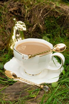 Cup of coffee on grass in the morning, coffee time in the morning, vertical image