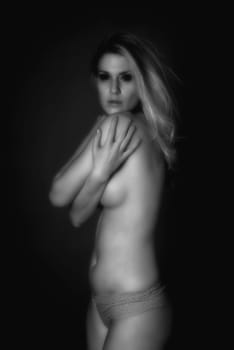 Soft focus infrared black and white sensual beautiful woman with perfect body posing nude