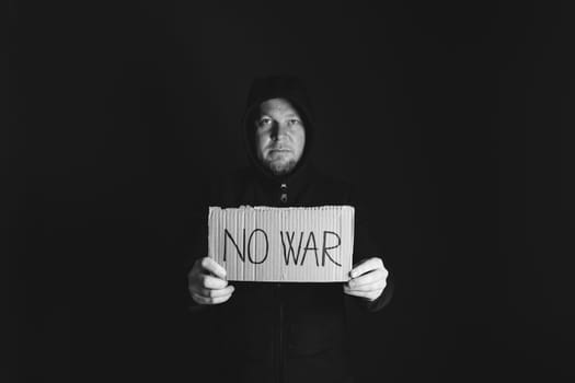 Man holding placard No war text. Freedom to Ukraine concept.