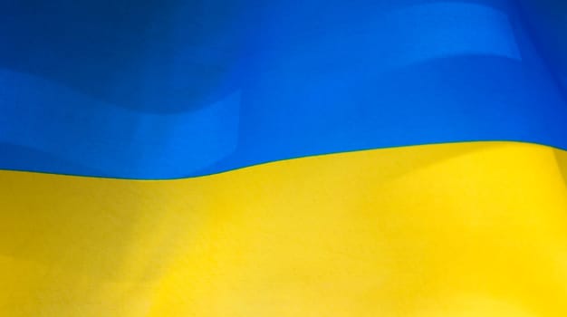 Flag of Ukraine, UA. Blue and yellow colors. Close up shot, background